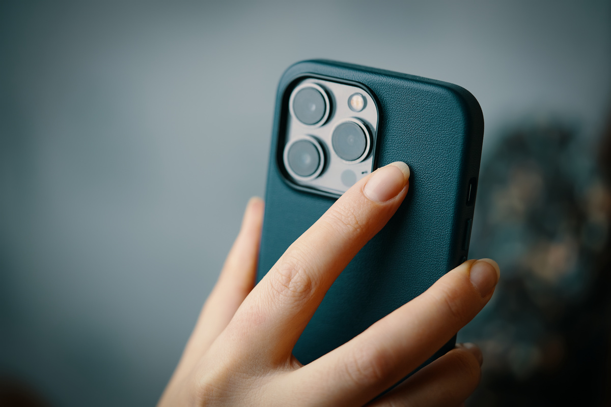Female's hands with iPhone 13 pro.